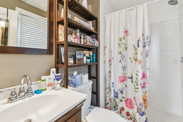 bathroom with toilet, vanity, and a shower with shower curtain