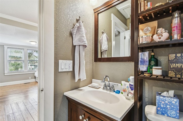 bathroom with vanity, wood-type flooring, and ornamental molding