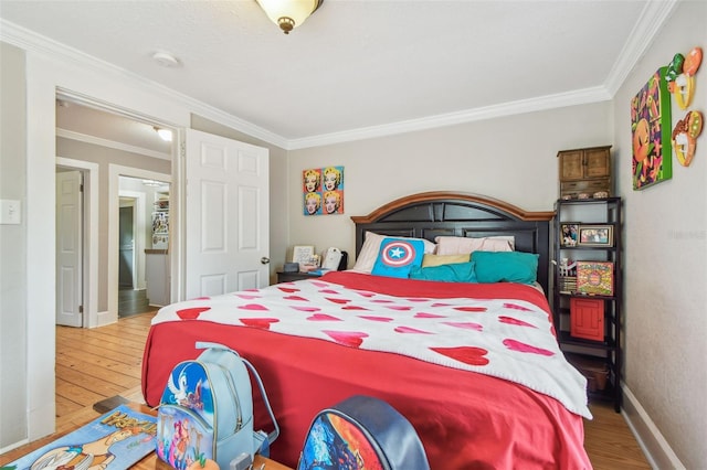 bedroom featuring crown molding and hardwood / wood-style floors