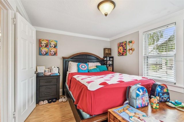 bedroom featuring hardwood / wood-style flooring and ornamental molding