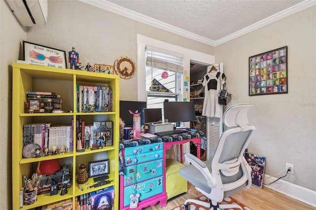 office with crown molding, a wall mounted air conditioner, wood-type flooring, and a textured ceiling