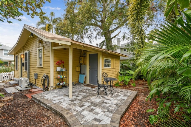 back of property with a patio and ac unit