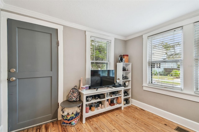 interior space featuring crown molding and hardwood / wood-style flooring