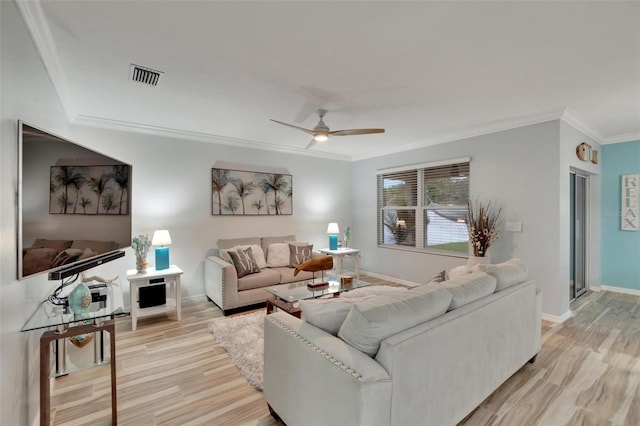 living room with crown molding, ceiling fan, and light hardwood / wood-style floors