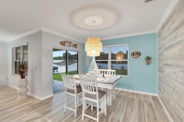 dining space featuring crown molding and light hardwood / wood-style floors