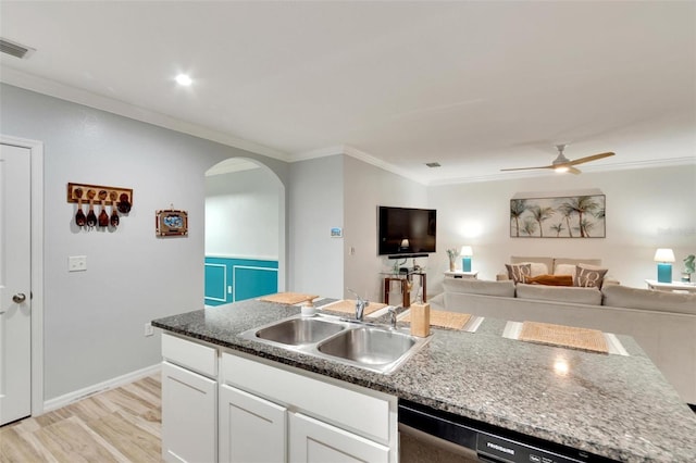 kitchen with ornamental molding, dishwasher, sink, and white cabinets