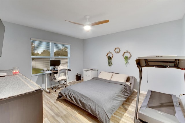 bedroom with light hardwood / wood-style flooring and ceiling fan