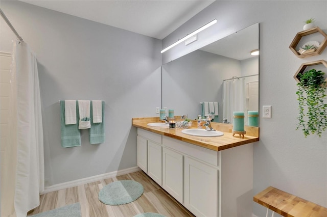 bathroom with vanity, wood-type flooring, and walk in shower