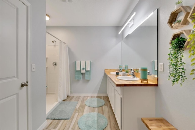 bathroom featuring vanity, hardwood / wood-style floors, and a shower with curtain