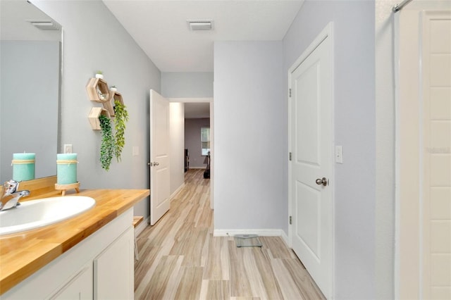 bathroom with vanity and hardwood / wood-style floors