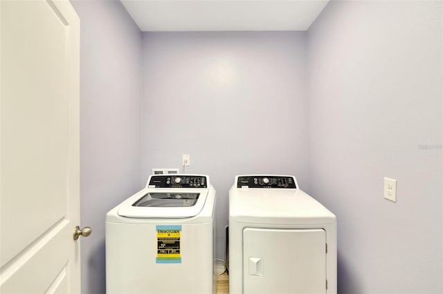 clothes washing area with washing machine and clothes dryer