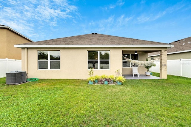 back of house with a yard, central AC unit, and a patio area