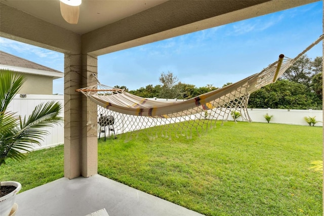 view of yard featuring ceiling fan and a patio area