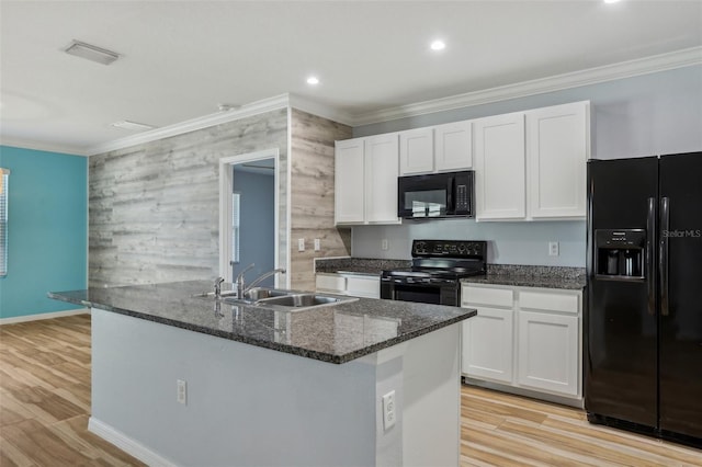 kitchen featuring a sink, black appliances, white cabinets, and crown molding