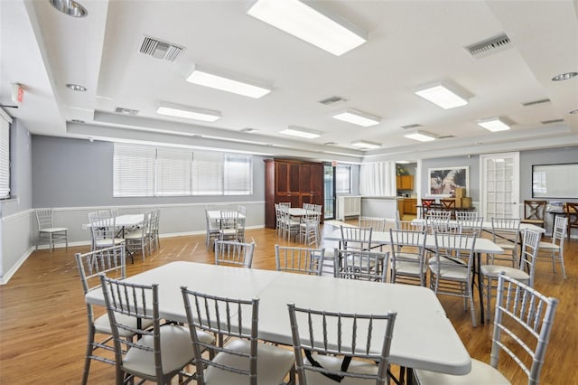 dining room featuring visible vents and wood finished floors