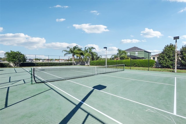 view of sport court featuring fence