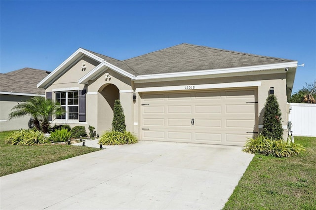 ranch-style home with stucco siding, driveway, and roof with shingles