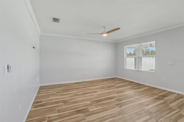 unfurnished room with visible vents, baseboards, light wood-style flooring, and crown molding