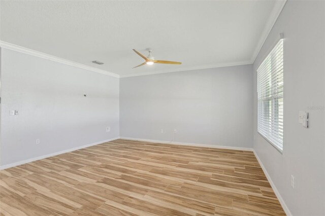 empty room featuring baseboards, a ceiling fan, light wood-style floors, and ornamental molding