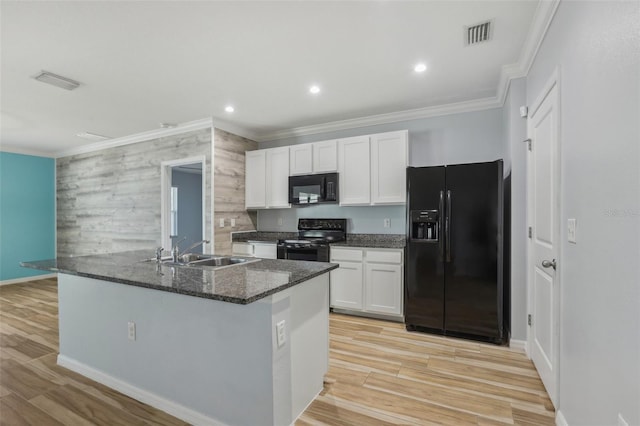 kitchen with visible vents, ornamental molding, white cabinets, black appliances, and a sink