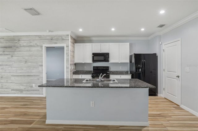 kitchen featuring visible vents, a sink, black appliances, white cabinets, and light wood-style floors