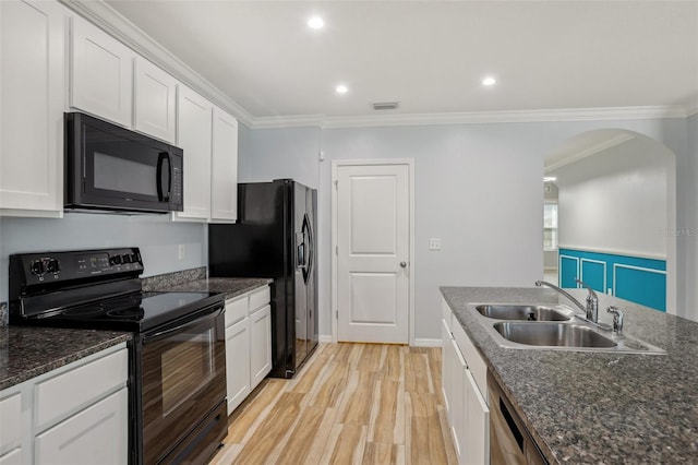 kitchen with a sink, black appliances, ornamental molding, and white cabinets