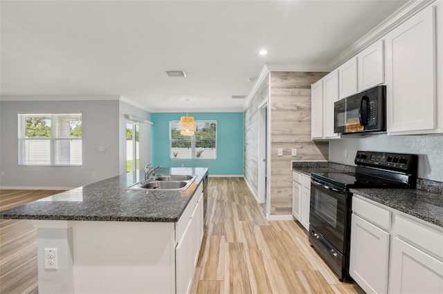 kitchen with black appliances, crown molding, a kitchen island with sink, and a sink