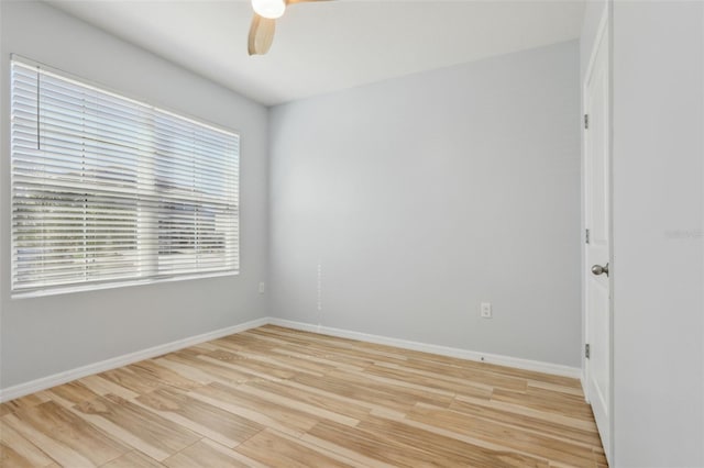 unfurnished room with light wood-style floors, baseboards, and ceiling fan