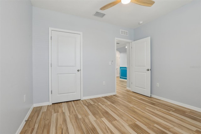 unfurnished bedroom with visible vents, baseboards, and light wood-style floors