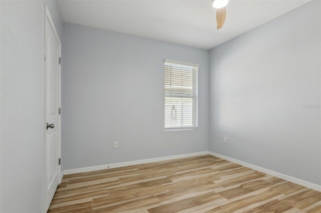 unfurnished room featuring ceiling fan, light wood-type flooring, and baseboards