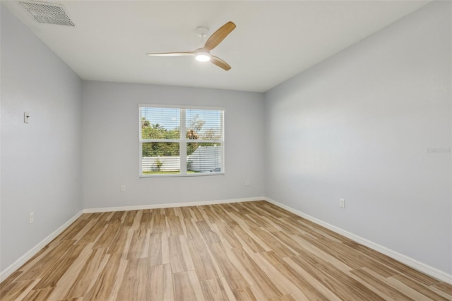 spare room with visible vents, baseboards, light wood-style floors, and ceiling fan