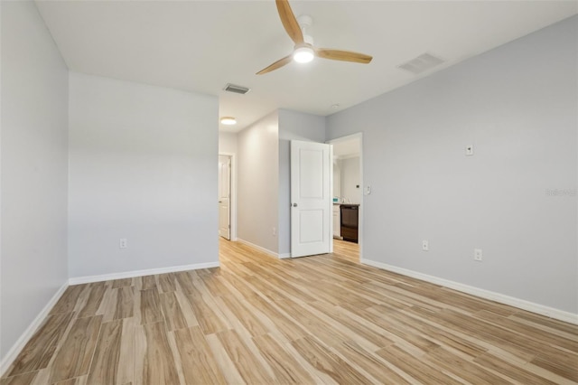 unfurnished bedroom featuring visible vents, baseboards, and light wood-style flooring