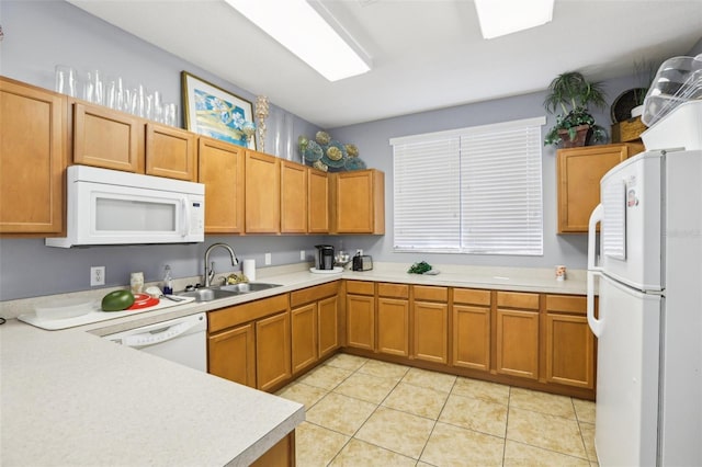 kitchen featuring a sink, white appliances, light tile patterned flooring, brown cabinetry, and light countertops