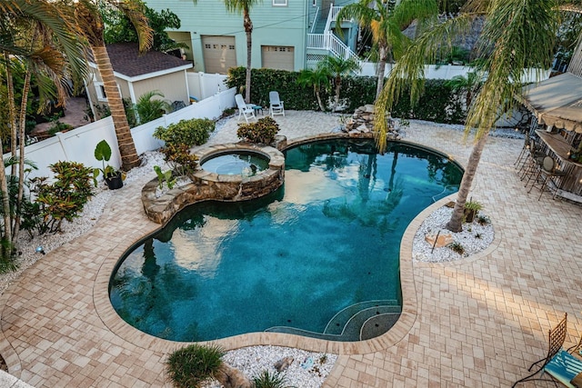 view of pool with an in ground hot tub