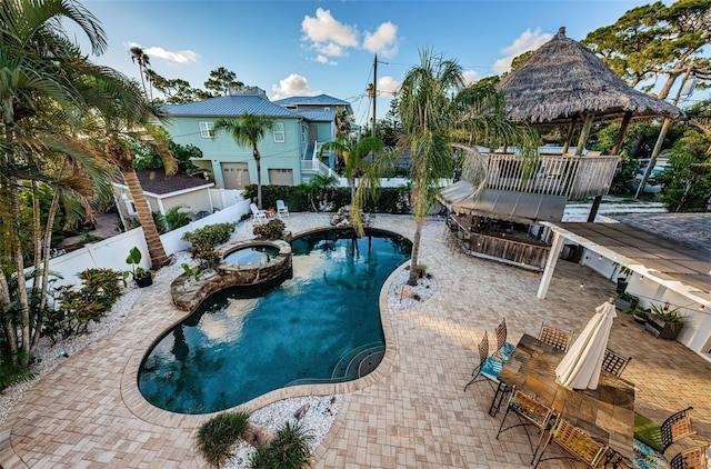 view of pool with a bar, a gazebo, and a patio area