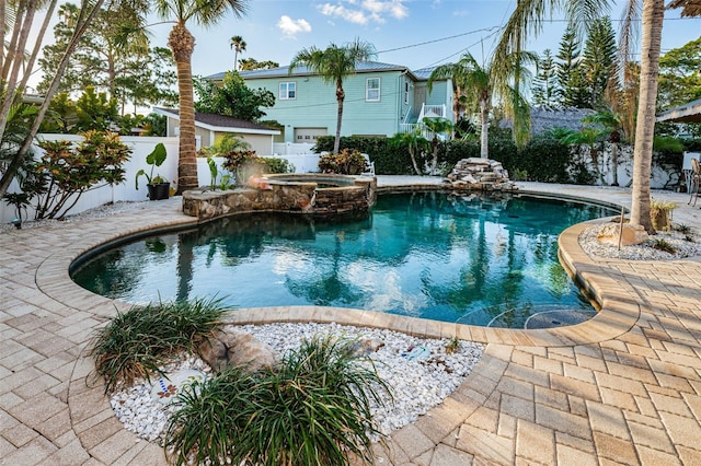 view of pool featuring an in ground hot tub