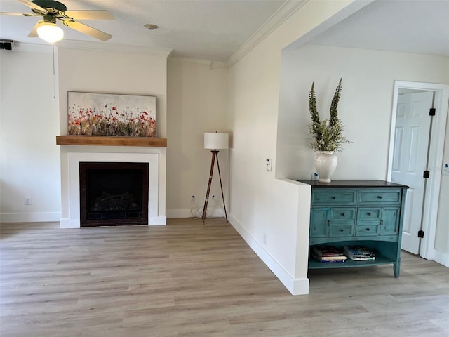 unfurnished living room featuring light hardwood / wood-style flooring, ornamental molding, and ceiling fan