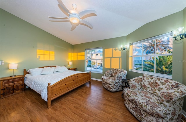 bedroom featuring hardwood / wood-style flooring, vaulted ceiling, and ceiling fan