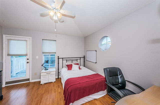 bedroom featuring ceiling fan, vaulted ceiling, and light hardwood / wood-style flooring