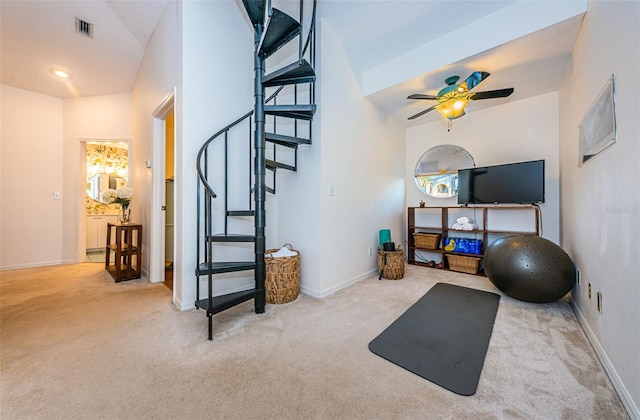 workout area featuring light colored carpet and ceiling fan