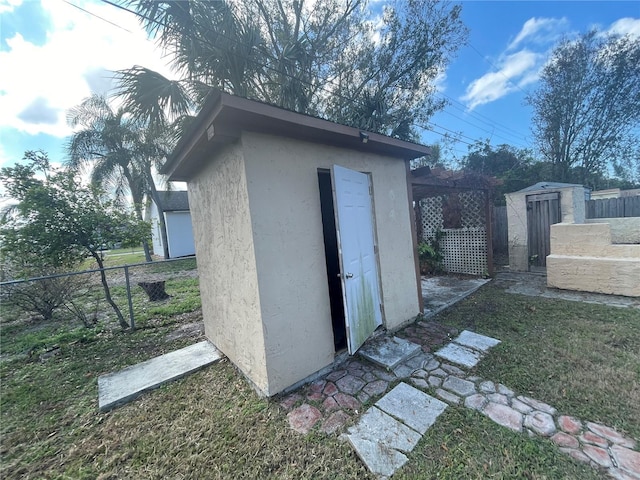 view of outdoor structure featuring a lawn