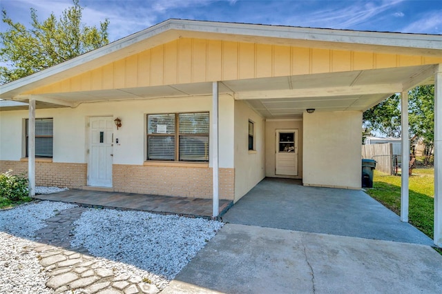 540 Florida Cir S, Apollo Beach, FL 33572 - bungalow-style house with an attached carport, brick siding, fence, and stucco siding