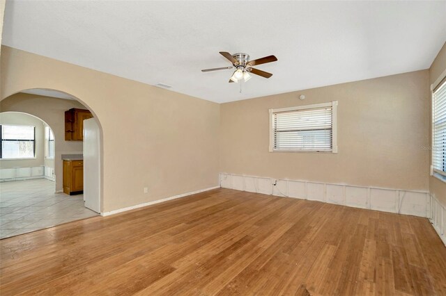 540 Florida Cir S, Apollo Beach, FL 33572 - unfurnished room featuring light wood-style flooring, arched walkways, and ceiling fan