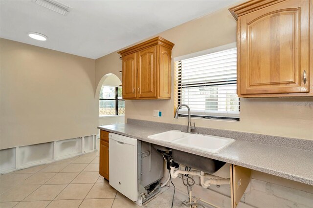 540 Florida Cir S, Apollo Beach, FL 33572 - kitchen featuring light countertops, a sink, white dishwasher, visible vents, and arched walkways