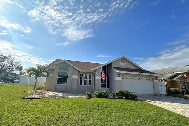 single story home featuring a garage and a front yard