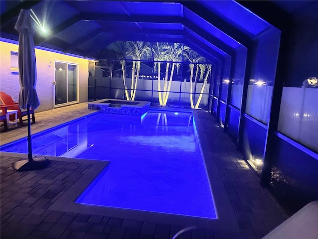 view of swimming pool featuring an in ground hot tub, a lanai, and a patio area