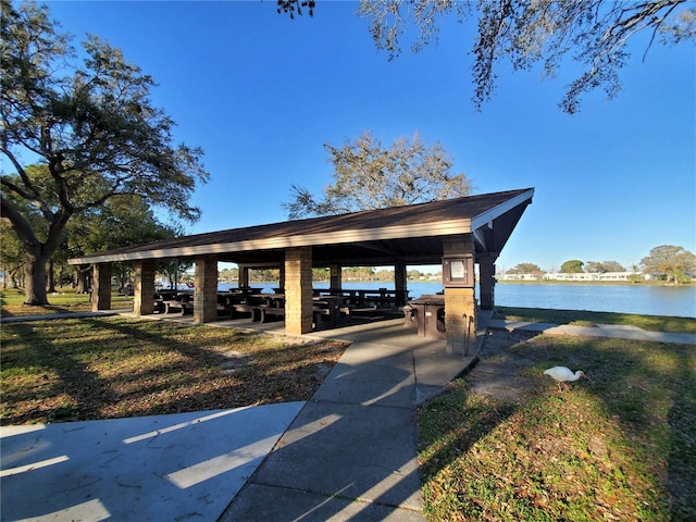 surrounding community with a gazebo and a water view