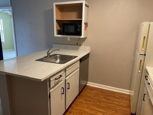 kitchen featuring sink, white cabinetry, black microwave, stainless steel dishwasher, and kitchen peninsula