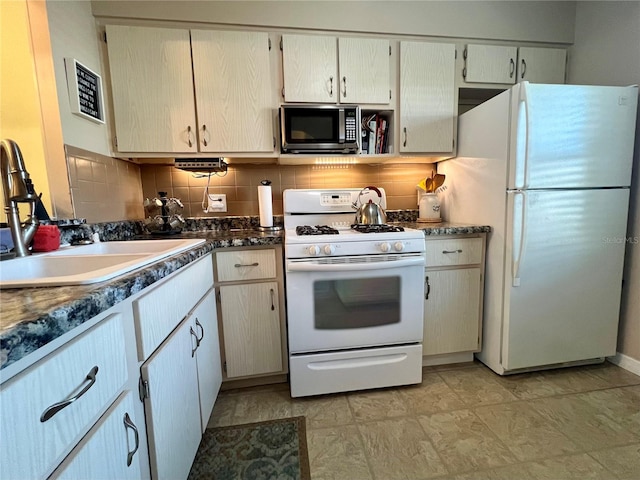 kitchen with tasteful backsplash, sink, and white appliances