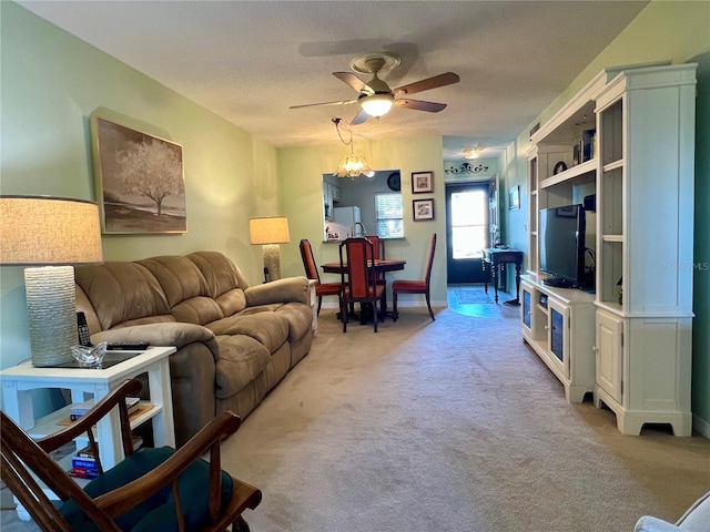 carpeted living room with ceiling fan and a textured ceiling